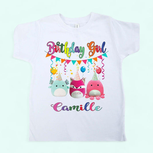 A white Squishmallows birthday shirt with 'Birthday Girl' text and 3 squishmallows